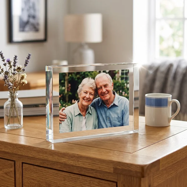 Large rectangular crystal photo block displayed on a table with a family photo inside.
